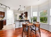 Thumbnail 3 of 39 - an open kitchen and dining room with a table and chairs at Sovereign at Overland Park, Overland Park