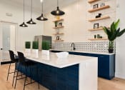 Thumbnail 21 of 39 - a blue and white kitchen with a white counter top at Sovereign at Overland Park, Kansas