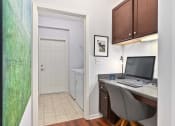 Thumbnail 8 of 39 - a office with a computer desk and a door to a bathroom at Sovereign at Overland Park, Overland Park, KS