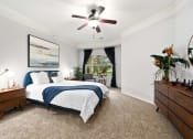 Thumbnail 12 of 39 - a bedroom with a bed and a ceiling fan at Sovereign at Overland Park, Overland Park, 66213