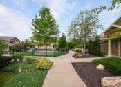 Thumbnail 16 of 39 - the walkway through the neighborhood is lined with trees and bushes at Sovereign at Overland Park, Overland Park, 66213