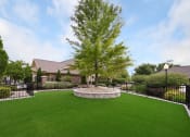 Thumbnail 17 of 39 - a yard with a tree and a house in the background at Sovereign at Overland Park, Overland Park, KS 66213