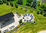 Thumbnail 38 of 62 - A backyard with a patio and a fire pit. at Overland Park, Pickerington, 43147