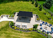 Thumbnail 62 of 62 - A patio with a fire pit and chairs is surrounded by a grassy area. at Overland Park, Pickerington, OH