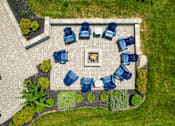 Thumbnail 40 of 62 - A fire pit surrounded by blue chairs in a garden. at Overland Park, Pickerington, Ohio