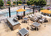 Thumbnail 27 of 59 - A pool area with a hot tub and lounging chairs. at Penn Circle, Carmel, 46032