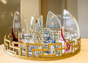 Thumbnail 42 of 59 - A glass trophy with a red ribbon is placed on a gold base. at Penn Circle, Carmel