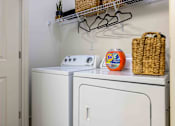 Thumbnail 14 of 59 - A white washing machine and dryer in a small laundry room. at Penn Circle, Carmel, IN, 46032