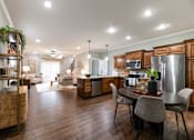 Thumbnail 2 of 63 - A modern kitchen with a dining table and chairs.