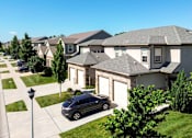 Thumbnail 63 of 63 - A grey car is parked in front of a house.