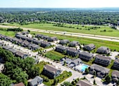 Thumbnail 54 of 63 - A bird's eye view of a residential area with houses and a swimming pool.
