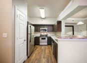 Thumbnail 10 of 38 - galley kitchen with stainless steel appliances at River Pointe, Conroe, TX, 77304