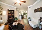 Thumbnail 13 of 38 - living area off kitchen with ceiling fan and wood style flooring at River Pointe, Conroe, 77304