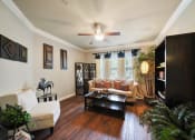 Thumbnail 14 of 38 - living area with wood flooring and natural light at River Pointe, Conroe, 77304