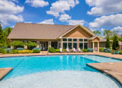 Thumbnail 35 of 39 - a swimming pool with a house in the background at Sovereign at Overland Park, Overland Park, KS 66213