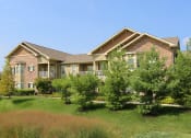 Thumbnail 38 of 39 - a large brick house with trees in front of it at Sovereign at Overland Park, Overland Park Kansas