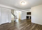 Thumbnail 6 of 43 - A room with wooden floors and white walls at Spring Creek Townhomes Apartments, Springfield, Illinois