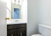 Thumbnail 9 of 43 - A white sink is in front of a mirror in a bathroom at Spring Creek Townhomes Apartments, Springfield, IL