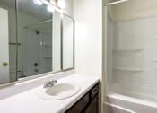 Thumbnail 8 of 43 - A white sink with a mirror above it at Spring Creek Townhomes Apartments, Springfield 62702