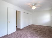 Thumbnail 19 of 43 - A room with a ceiling fan and carpeted floor at Spring Creek Townhomes Apartments, Illinois