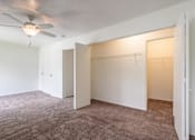 Thumbnail 16 of 43 - A room with a ceiling fan and carpeted floor at Spring Creek Townhomes Apartments, Springfield