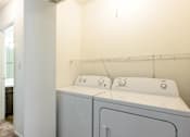 Thumbnail 15 of 43 - A laundry room with a washer and dryer at Spring Creek Townhomes Apartments, Illinois