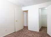 Thumbnail 18 of 43 - A white door with a gold handle is in a room with carpeted flooring at Spring Creek Townhomes Apartments, Illinois 62702