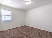 Thumbnail 20 of 43 - A room with a window and carpeted floor at Spring Creek Townhomes Apartments, Springfield, IL