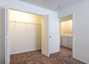 Thumbnail 14 of 43 - A bedroom with a white door open to a bathroom at Spring Creek Townhomes Apartments, Springfield