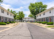 Thumbnail 39 of 43 - A street view of a residential area with houses on both sides at Spring Creek Townhomes Apartments, Springfield 62702