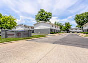 Thumbnail 41 of 43 - A street view of a residential area with houses and a sign that reads at Spring Creek Townhomes Apartments, Springfield, Illinois