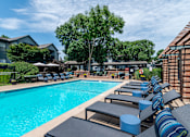 Thumbnail 12 of 46 - Pool with Sun Loungers at Springhill Apartments, Overland Park, KS, 66213