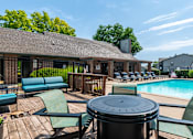 Thumbnail 18 of 46 - Poolside area with seating at Springhill Apartments, Overland Park, Kansas
