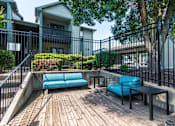 Thumbnail 13 of 46 - Wooden Deck with blue couch at Springhill Apartments, Overland Park
