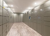 Thumbnail 9 of 42 - A long hallway with a series of lockers on the wall.