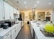 Thumbnail 19 of 59 - A kitchen with white cabinets and a black refrigerator. at The Greyson, Ohio, 43026