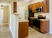 Thumbnail 11 of 66 - A kitchen with wooden cabinets and a black refrigerator  at The Greyson, OH