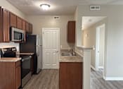 Thumbnail 13 of 66 - A kitchen with a black refrigerator and stove top oven  at The Greyson, Ohio