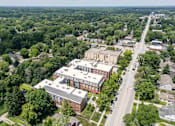 Thumbnail 55 of 73 - An aerial view of a street with a red brick building on the corner. at The MK, Indiana, 46220