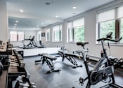 Thumbnail 9 of 73 - A gym with a row of treadmills and stationary bikes. at The MK, Indiana, 46220