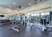 Thumbnail 31 of 53 - A gym with a variety of equipment and a sign that says at Sovereign at Overland Park Apartments, Overland Park, KS 66213