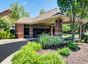 Thumbnail 36 of 53 - A house with a red brick chimney and a brown roof with a landscaped front yard at Sovereign at Overland Park Apartments, Overland Park, KS 66213
