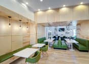 Thumbnail 27 of 53 - A modern dining area with green chairs and tables at Sovereign at Overland Park Apartments, Overland Park, 66213