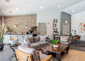 Thumbnail 11 of 50 - A living room with a grey couch and a wooden coffee table.