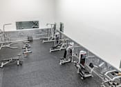 Thumbnail 14 of 50 - A gym with a variety of exercise equipment.