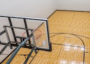 Thumbnail 18 of 50 - A basketball court with a hoop and a net.