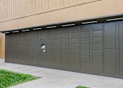 Thumbnail 6 of 50 - A large grey garage door with a small square window in the middle.