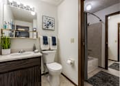 Thumbnail 42 of 50 - A bathroom with a white toilet and a white sink.
