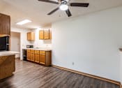 Thumbnail 47 of 50 - A kitchen with wooden cabinets and a ceiling fan.