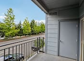 Thumbnail 45 of 59 - A balcony with a black railing and a grey door.